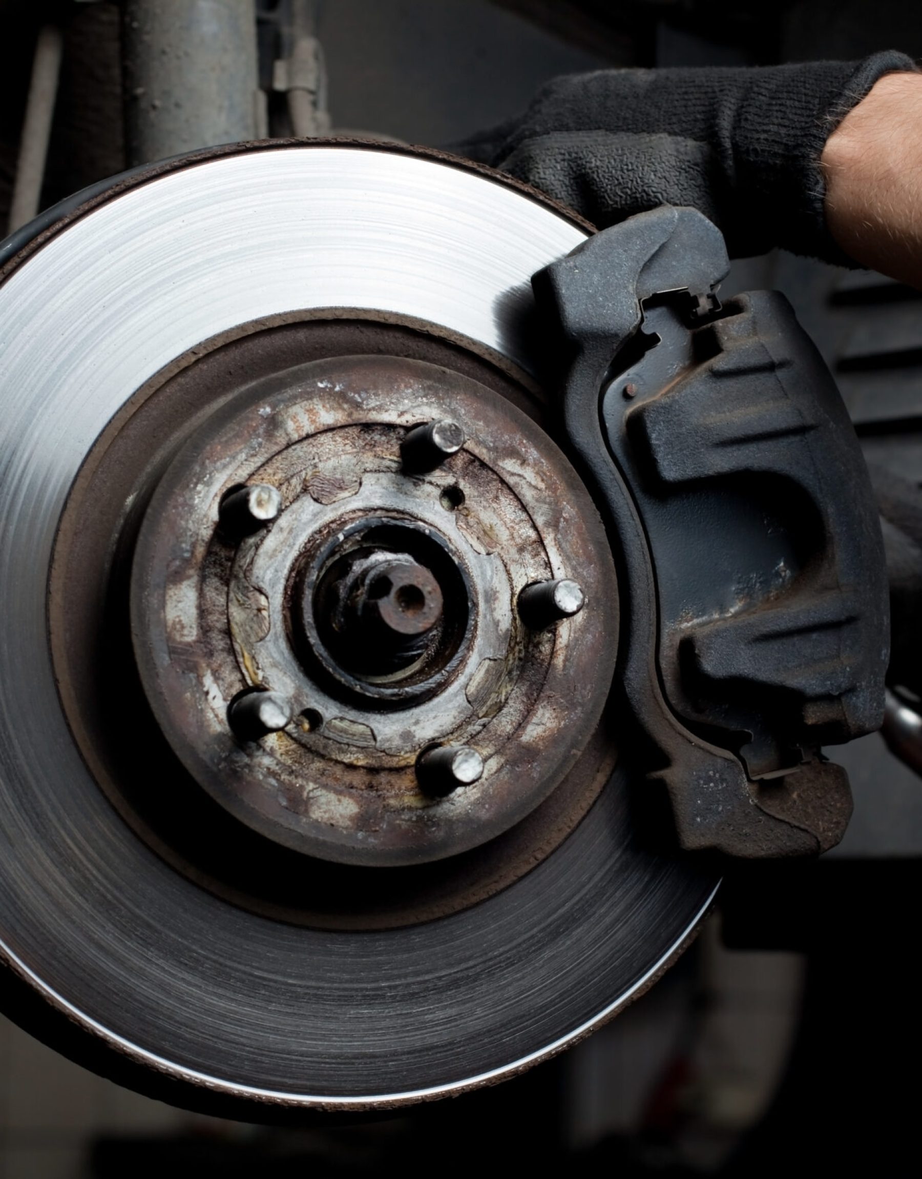 Closeup of car mechanic repairing brake pads